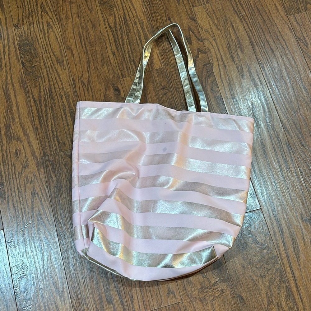 Macy's pink and gold striped tote bag featuring shimmering metallic stripes